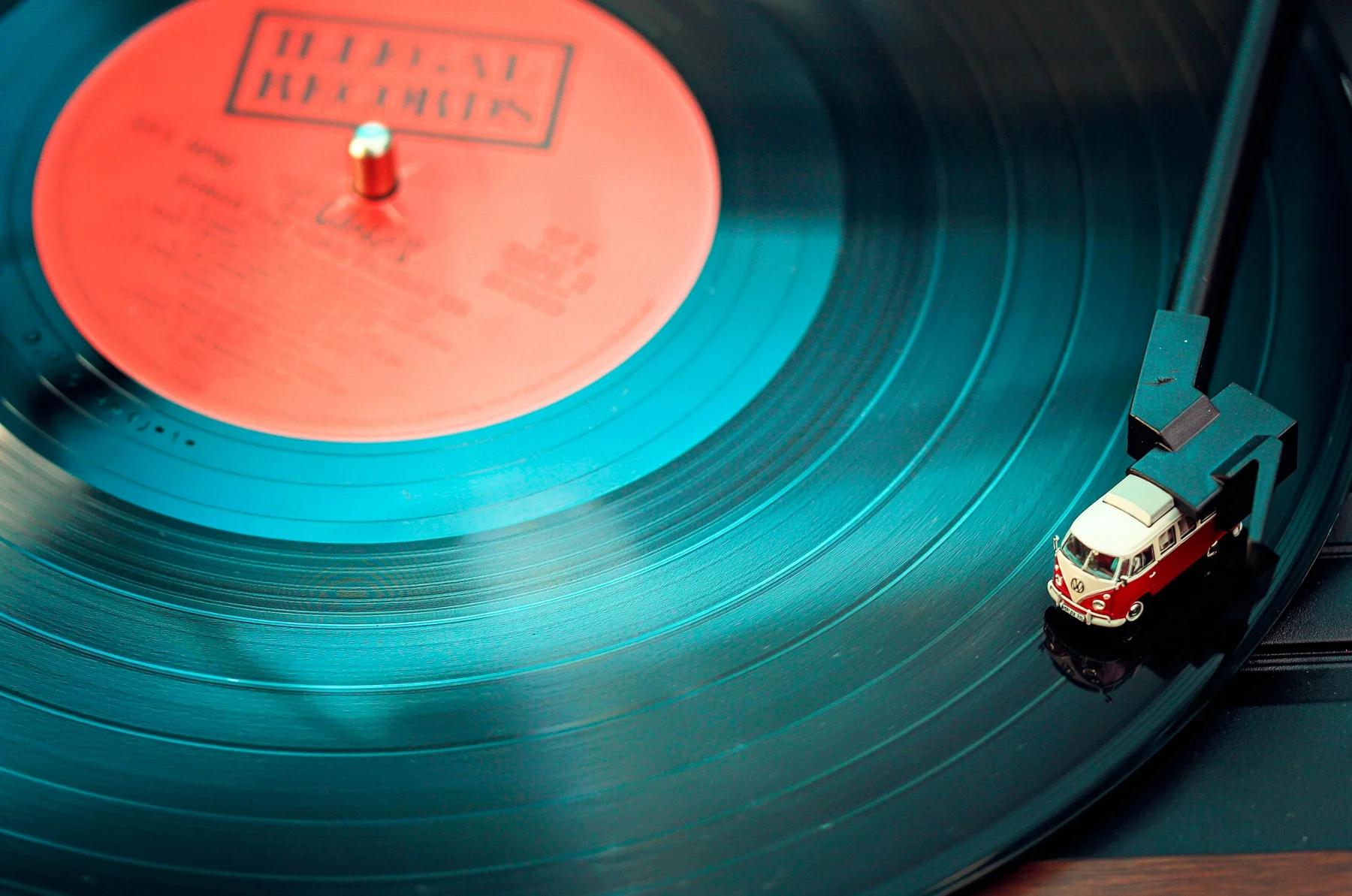 Miniature red and white van integrated into a record player in place of its cartridge